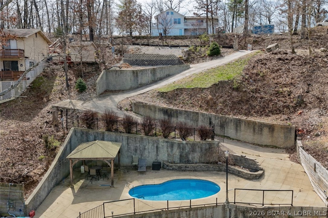 Rare opportunity to own a prime lakefront lot with 93 feet of shoreline in a protected cove, offering calm water and an unbeatable location by both land and water. This property is already well on its way to becoming your dream lake retreat, featuring an in-ground pool, private dock, and existing foundation walls - giving you the option to build from the current footprint or start fresh with your own custom design. Utilities are already in place with electric run to both the lot and dock, and the property is serviced by a shared well. The groundwork has been thoughtfully completed, with a soil analysis and engineered septic system already designed, saving you valuable time and upfront costs. Situated just minutes from the historic Bagnell Dam Strip, you’ll enjoy easy access to local dining, shopping, and entertainment while still having your own private place to relax by the water. Whether you're ready to build now or invest for the future, this property offers a head start that’s hard to find—complete with the key features that make lake living truly exceptional. Owner states that city water and sewer are available approximately 800 feet away if wanted.