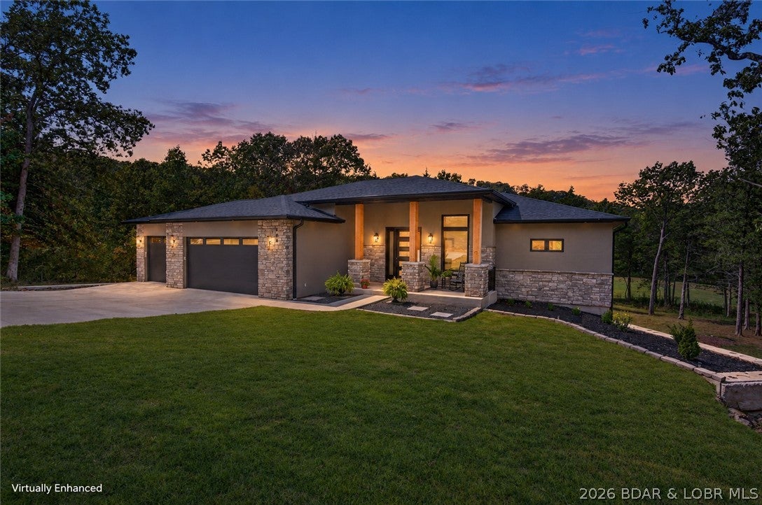 This is more than a brand-new home—it’s your invitation to live the Old Kinderhook lifestyle. Wake up along the 3rd hole, take the golf cart to dinner, spend summer afternoons at the pool and enjoy golf, fitness, basketball, tennis and spa days without leaving the community. At home, soaring ceilings, expansive windows and a striking fireplace create a light-filled gathering space overlooking the wooded golf-course setting. Cook, entertain and stay part of the conversation from the custom kitchen, where upgraded appliances and an oversized island anchor the room. Step onto the large deck for morning coffee, grilling or a quiet evening outdoors. Two main-level suites offer comfort and privacy, while the office can become a fifth bedroom. Downstairs feels made for hosting, with a walkout family room, second stone fireplace, future wet bar and two additional bedroom suites—giving guests room to settle in. The level driveway, oversized 3-car garage and lower golf-cart garage/workshop make lake and golf life effortless. The large level yard leaves space for a future pool, fire pit and the memories you’ll create around them. Marina access and resort amenities complete the experience.