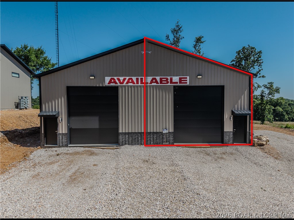 This newly constructed, multi-purpose shop is ideally located at the intersection of Highway 135 and Highway 5 in Laurie, Missouri. Sitting on a level lot, this 25’ x 60’ unit offers exceptional functionality with 16-foot ceilings and an oversized 12’ wide x 14’ tall garage door—perfect for accommodating large vehicles, equipment, or recreational toys. Built with quality in mind, the structure features 2x6 construction, textured drywall, full insulation, and 200-amp electrical service. Plumbing is roughed in and ready for a bathroom installation, with access to city sewer—providing flexibility for future upgrades. Designed for year-round use, the unit includes a 100-inch industrial ceiling fan and a 50,000 BTU forced-air gas furnace to ensure climate control in all seasons. There Is a RV Clean Out Located on the side of the Building. Whether you’re looking for a personal man cave, storage for vehicles or gear, a workshop, or a commercial-use space, this unit offers endless possibilities. Just 5 minutes from Ozarks International Raceway, this location is both convenient & highly desirable.
