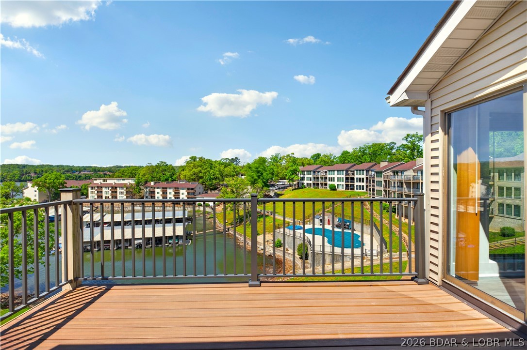 123 Barba Le Lane #3A in Lake Ozark at Robinwood Condos offers a warm and inviting way to enjoy lake life. This top floor, end unit condo features 2 bedrooms, 2 baths, and a bright open layout with vaulted ceilings, a beautiful stone fireplace, and easy access to the deck for relaxing cove and main channel views. Recent updates include new flooring, fresh paint, and updated window and sliding door glass, giving the space a clean and refreshed feel. With a community pool, clubhouse, tennis courts, community dock, 12x28 slip with hoist, and PWC lift, this property is ready for full-time living, weekend escapes, or rental potential.