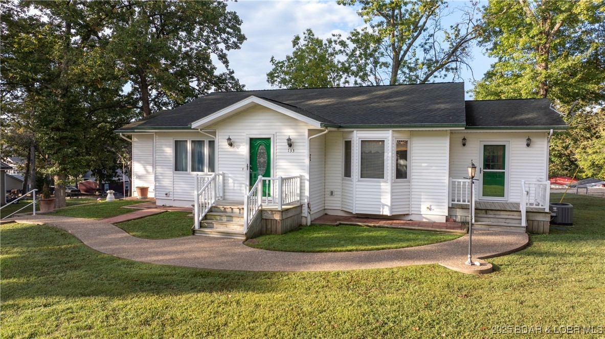 Discover comfort & tranquility in this beautiful 3-bedroom (one bedroom is non-conforming), 2-bath home offering just over 3000 square feet of living space. Enjoy lake views from the main level deck or relax on the inviting patio below. The open-concept main level is warm & welcoming, perfect for entertaining or quiet evenings at home. The walk-out basement adds incredible versatility—ideal for a family room, home gym, or hobby space—with plenty of natural light & direct outdoor access. With abundant storage throughout the home, making it easy to stay organized & clutter-free as well as cozy touches at every turn, this home combines functionality, relaxation, & scenic beauty in one perfect package. Located just minutes from local shops, grocery stores, & popular lake area restaurants, this home offers the perfect balance of peaceful living and everyday convenience. Enjoy the serenity of lake life without giving up easy access to all your favorite spots for dining, shopping, and recreation.  Also, there's plenty of room to build an attached garage and/or a detached garage / workshop should you want.  Come see what makes this house a home for yourself and plan to be amazed.