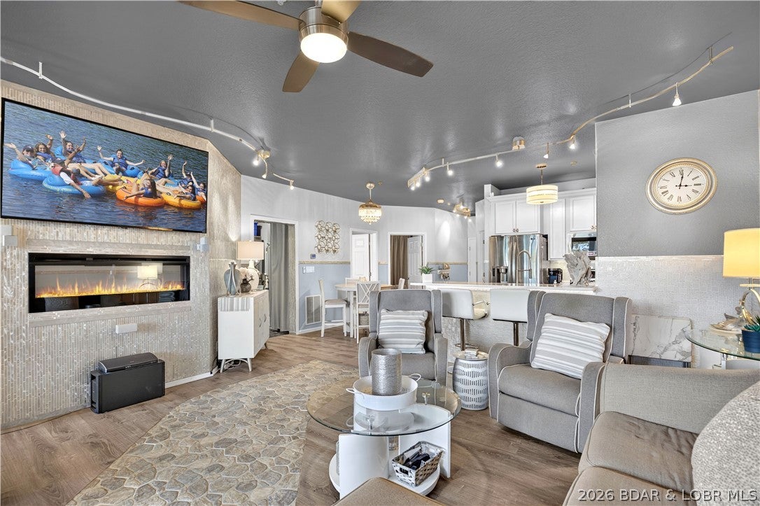 GLITZ AND GLAMOUR!  Even better in person! Welcome to Isla del Sol – island living at the Lake of the Ozarks! Take the elevator down to this furnished 3BR/2BA condo at the 3MM, complete with a 14x36 boat slip and ready to enjoy from day one. The open living area features an electric fireplace and flows easily into the kitchen and dining space, creating a comfortable setup for entertaining. Sliding doors lead to the private screened-in deck, where a built-in bar and lake views create the perfect extension of your living space. The primary suite offers its own view of the water, while two additional bedrooms provide plenty of room for family and guests. An in-unit stacked washer/dryer and stainless refrigerator with built-in kegerator add even more convenience for lake weekends. Isla del Sol offers a resort-style pool overlooking the water, iconic lighthouse, assigned parking, elevator access and a truly unique island setting. Whether you're looking for a full-time residence, weekend escape or rental opportunity, this one puts the Lake lifestyle right at your doorstep!