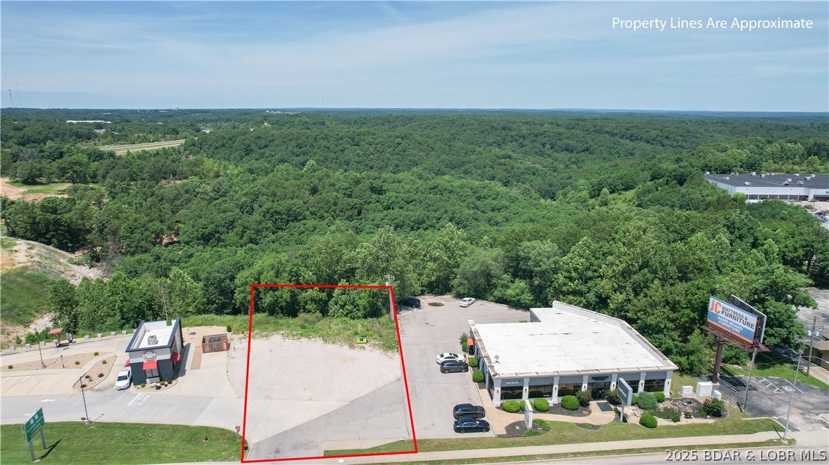 Prime commercial opportunity in a high-visibility location next to Scooter’s Coffee with direct frontage on Highway 54! This prominently positioned site offers unmatched exposure, with over 24,000 cars passing daily according to the 2023 MoDOT map. Conveniently located near the lake, fishing, golf courses, schools, bars, and restaurants, this property is perfectly placed for a variety of business ventures. City Water and Sewer connections are easily accessible, and the C-2 zoning offers flexible commercial possibilities. Whether you're launching a retail space, service business, or professional office, this lot delivers location, traffic, and convenience. Some restrictions apply to adjoining businesses, ensuring a strong surrounding mix. With growing development in the area and Osage Beach's continued expansion, this is a smart investment with huge potential. Ready for your next venture? Don’t miss your chance to secure a premier spot in one of the Lake’s fastest-growing corridors—inquire today!