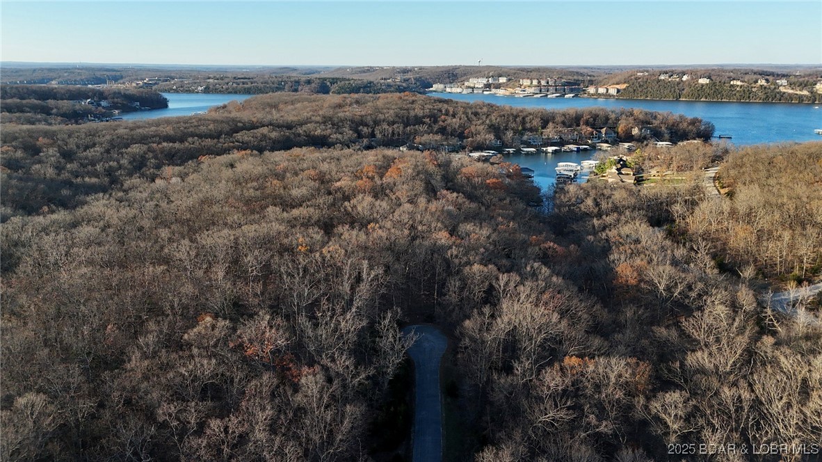 Embrace the lifestyle that comes with ownership in Porta Cima, offering fantastic community perks including access to a boat ramp, campground, clubhouse, community pool, dog park, playground, and tennis courts. Road maintenance is also covered, allowing you to focus on enjoying your new home. Seize this chance to create your personal oasis in a tranquil environment where natural beauty harmonizes with modern conveniences. Come see the potential this enchanting lot holds!