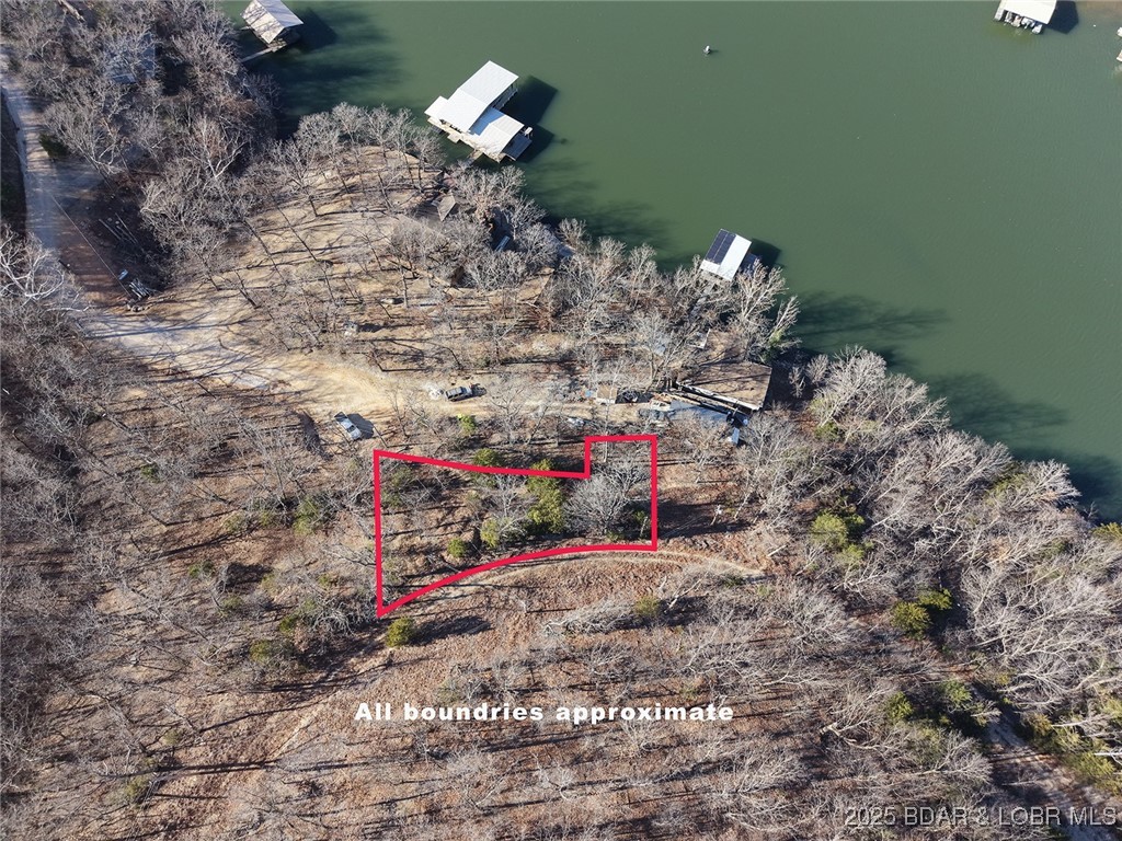 Discover your blank canvas for your lakeview cabin or tiny home! This parcel off Harvest Road offers views of the water, nestled in a peaceful, wooded setting just minutes from all the action. Conveniently located only 10 minutes from Camdenton for shopping, dining, and essentials, and a mere 5 minutes off State Highway 5, it’s suited for building a cozy tiny home or charming cabin. Imagine waking up to serene lake vistas with the beauty of the Ozarks as your backdrop—whether you’re seeking a weekend retreat, a minimalist lakeside haven, or a smart investment in this sought-after area, this property delivers seclusion without sacrificing convenience. Power on pole at the property. Don’t miss this rare opportunity to own a slice of Lake of the Ozarks paradise—properties like this don’t last long! Contact me today to schedule a viewing and start planning your dream.