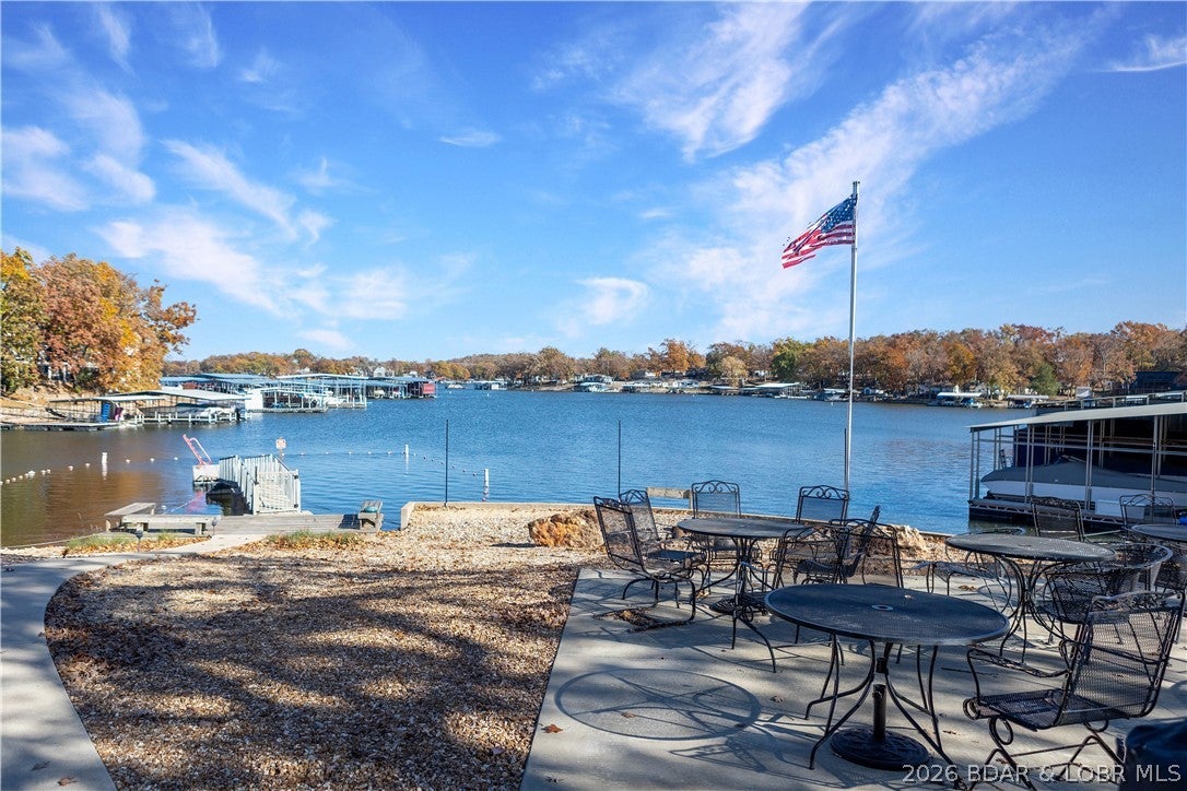 Enjoy stunning views and low-maintenance living in this 2-bedroom, 2-bath lake-view condo offering 1274 sq. ft. of comfort and convenience. Step inside to find an open-concept layout filled with natural light, a spacious kitchen with ample counter space, and a living area that opens to a private deck — the perfect place to relax and soak in the Lake of the Ozarks scenery. The primary suite offers peaceful views and a private bath, while the guest room and second full bath provide ideal space for family or visitors. Whether you’re looking for a weekend retreat, a full-time residence, or a short-term rental opportunity, this condo checks every box. Community amenities include a pool, dock access, playground, fire pit, BBQ area, swim dock, clubhouse, and nearby dining and entertainment — everything you need for effortless lake living!