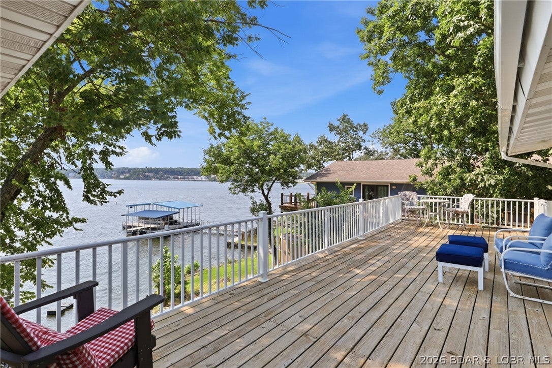 Wake up to the Lake of the Ozarks lifestyle you've been dreaming about! Fully remodeled and move-in ready, this 3BR/2BA lakefront home in Sunrise Beach delivers 2,770 sq ft, 100 ft of waterfront and a main channel view in an incredible location close to everything. Designed for effortless lake living, the home features luxury vinyl plank flooring, a spacious kitchen with pantry, generous living areas and multiple outdoor spaces including an open deck, covered patio and patio. Head straight to your private 2-well dock with swim platform, slide, dock locker and PWC slip, plus a BOAT HOIST INCLUDED so you can start enjoying the water from day one. The largest slip is 10x24. Nightly rentals are allowed, creating exciting potential as a personal lake retreat, full-time residence or investment property. With community water, central air and easy access to dining, shopping and entertainment, this is where convenience meets waterfront fun. Picture mornings on the deck, afternoons boating and evenings watching the lake come alive. Don't just visit the Lake-live it! Schedule your private showing today! A rare combination of remodeled comfort, usable waterfront and rental flexibility awaits!