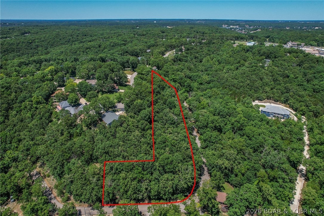 Prime 1.7-acre building parcel in the rapidly growing KK area, offering the perfect blend of convenience and lake lifestyle. Ideally located close to shopping, dining, entertainment, and all the amenities the Lake area has to offer. Enjoy lake access along with a 10x20 slip in the community dock. With ample acreage and excellent development potential, this property provides the opportunity to build your dream home, a family compound, or multiple homes. A rare chance to invest in prime Lake-area real estate with endless possibilities.