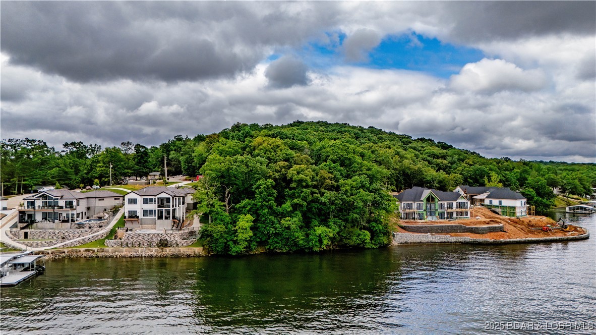 Build your dream lake home on this stunning lakefront lot featuring gentle topography and unobstructed panoramic main channel views at the 4MM. Located in a highly desirable area, right outside of Four Seasons, this property offers easy access to the water and endless possibilities for lakeside living. With a gentle slope ideal for a walkout build and views that stretch for miles, this is a rare opportunity to own a premium piece of Lake of the Ozarks shoreline.