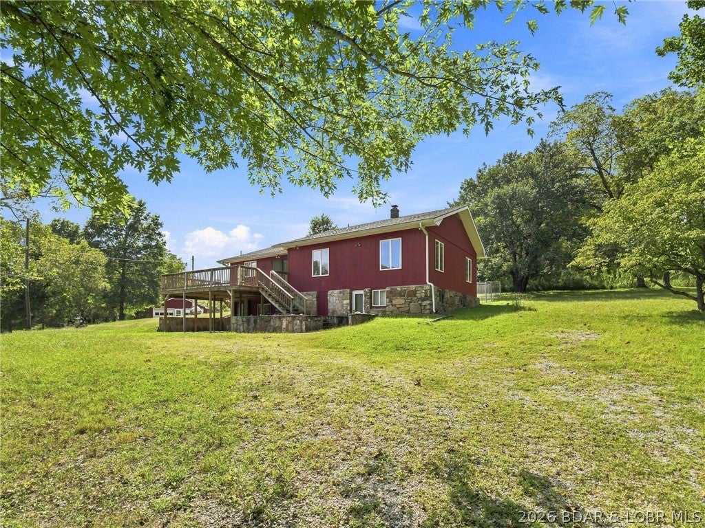 You won't find a country setting quite like this! Situated on 52 +/- beautiful acres, this well-maintained 2-bedroom, 2-bath home offers privacy, incredible views, a private pond, abundant storage, and endless possibilities. Inside, the main level features an open kitchen with plenty of cabinetry and a spacious living area with room for entertaining. The lower level provides additional space that could be finished for more living area or utilized for storage. Step outside and take in the peaceful setting from the deck overlooking the private pond. The acreage has been exceptionally well cared for and features a great combination of open pasture and timbered ground, creating opportunities for livestock, recreation, hunting, or future development. Outbuildings include an impressive 40'x102' barn offering tremendous shop, equipment, or storage potential, along with a 26'x32' detached 2-car garage. Tucked away down a gated private drive off paved Highway M, the property offers privacy while maintaining convenient access and approximately 4,000 feet of highway frontage. This 52 +/- acre property offers a combination of features that is hard to find!