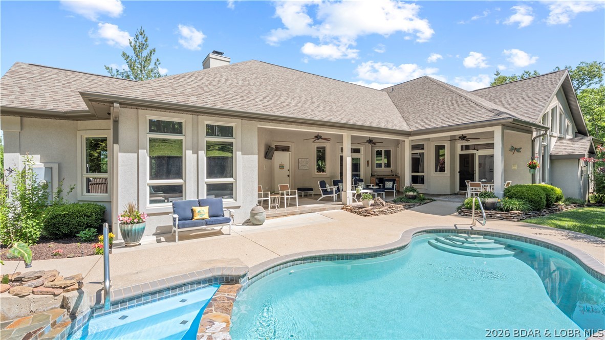 Experience the best of both worlds—peaceful privacy on 2.08 acres paired with the fun of lake living at the Lake of the Ozarks. Custom built with luxury and comfort in mind, this home features tall ceilings, extra-wide hallways and doorways, high-end finishes, and large windows showcasing beautiful backyard views.
The renovated kitchen is perfect for entertaining, while the stunning primary suite offers a private retreat. The layout works equally well for full-time living or hosting family and guests.
Outside, enjoy your own resort with a heated pool and waterfall, covered entertaining area, and mature landscaping creating a tropical escape. The large level driveway accommodates up to 12 vehicles plus RV or trailer parking, while gated access adds privacy.
Enjoy easy lake access via side-by-side, golf cart, or a short walk to the community dock with a 12’x32’ boat slip at the 31-mile marker in deep water. Located on the east side of Camdenton, you’re minutes from shopping, dining, and Highway 54.
An optional 40’x60’ Boat/RV garage is also available. This is more than a home—it’s lake living at its best.