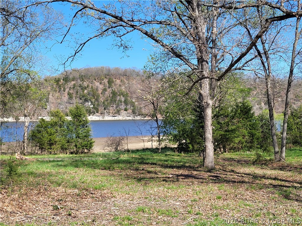 Own a prime piece of lakefront property at Lake of the Ozarks! This exceptional lot offers breathtaking main channel views paired with the tranquility of calmer waters—perfect for swimming, boating, and relaxing. Utilities are already in place, including water, electric, and sewer, making it ready for your dream build or vacation retreat. Located within a gated community with easy access, this property combines privacy with convenience. Enjoy stunning lake views and direct water access in one of the Midwest’s most sought-after destinations. This property checks all the boxes. Bring your offers and start living the lake life