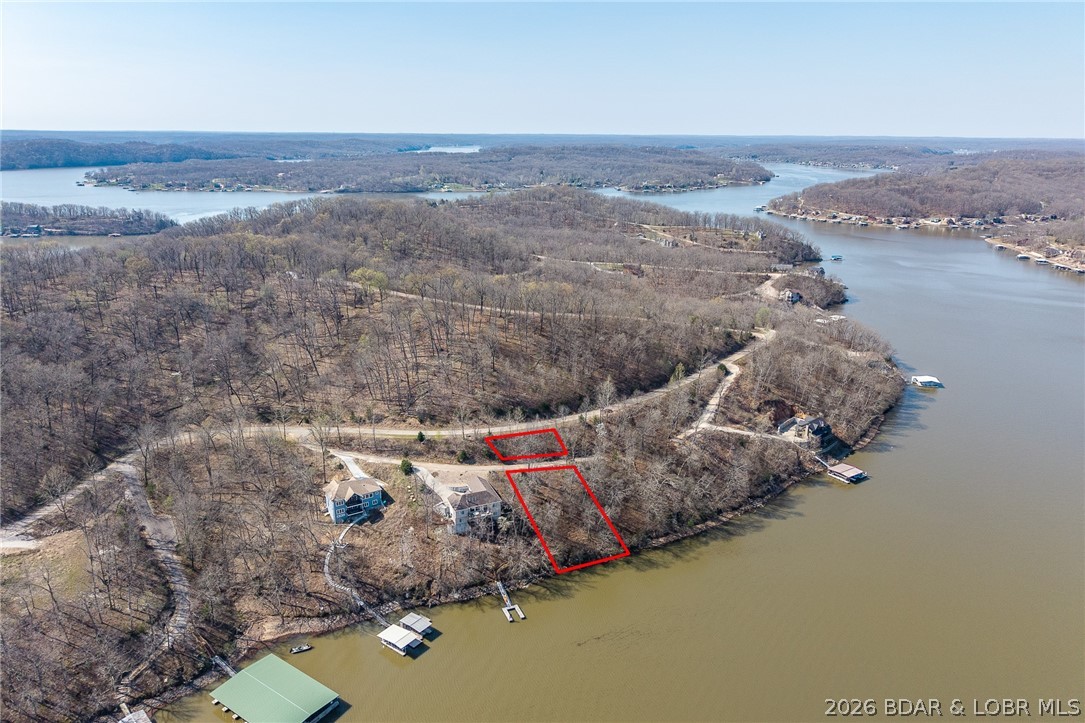 Lake Front lot ready for your dream home build! Located at the 55 Mile Marker of the Osage at Lake of the Ozarks this BEAUTIFUL area will WOW you! Community Water and Central Septic and paved roads all the way! DEEP water and a moderate slope to the land! Ready for you to make your own.