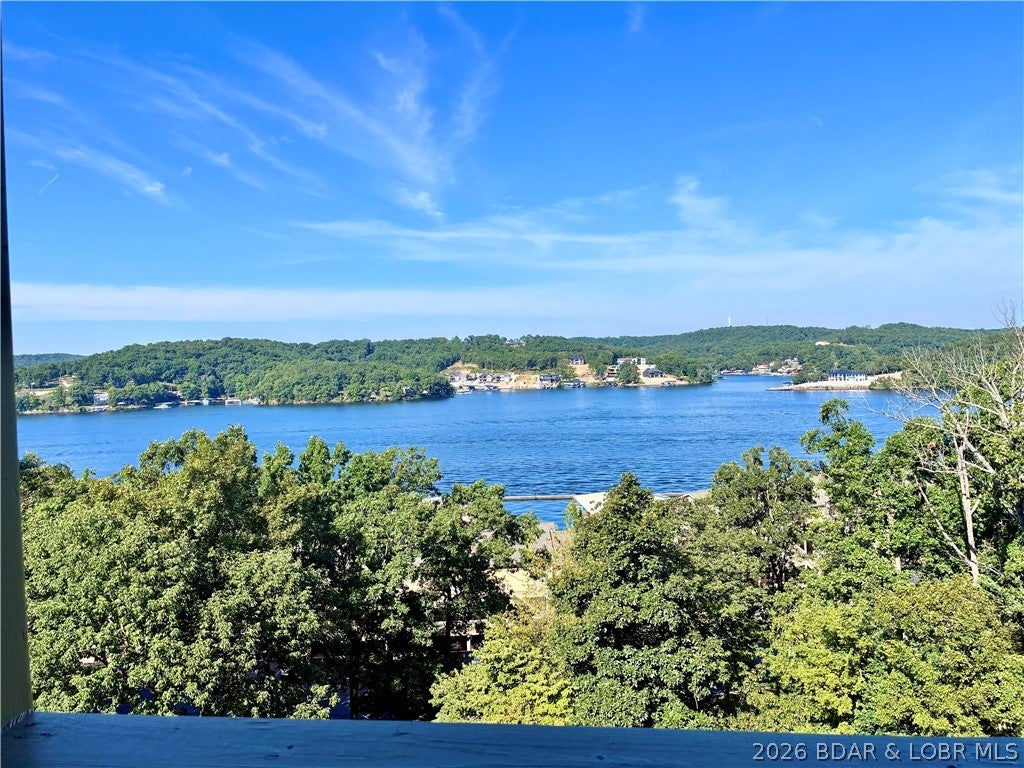Wake up to some of the best lake views at Bay Point Village. This freshly painted, rental-ready unit is move-in clean and positioned just steps from the upper pool—making it as convenient as it is inviting. No to-do list—just pure enjoyment from day one. Spend your mornings fishing, your afternoons enjoying the amenities including a new community fire pit, and your evenings unwinding. Just steps from the front door is a picnic table and barbeque pits. The beautifully tiled balcony will be your new happy place overlooking a peaceful, park-like setting and calming lake views. Retire to the generous primary en suite with floor to ceiling windows, and a large walk in closet. Your guests will rejoice at the tranquil second bedroom and guest bathroom. This is low-maintenance lake living exactly the way it should be.