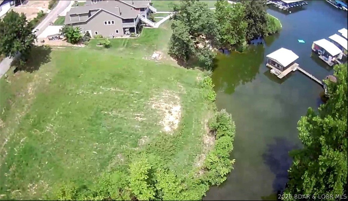 Ready to build on an almost level lot with central water & sewer, dock slip and pwc spot in a quiet cove. The subdivision has a clubhouse, pool and sand beach. Close to restaurants, banks, shopping & entertainment.  Single family dwellings only and building plans must be approved.  Access to the clubhouse and pool is restricted until a foundation is poured on your lot.  Walking distance to the Nauti Fish and minutes by water to the Cave Bar & Grill and Larry's.