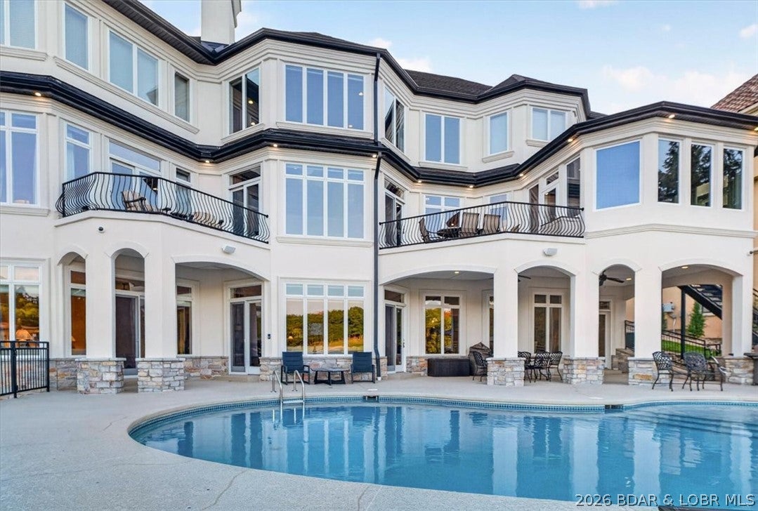 When searching for the perfect lakefront home, the search ends here. This extraordinary East-facing estate combines breathtaking golf course and main-channel views, exceptional waterfront amenities, luxurious living spaces, and timeless craftsmanship. Set on a nearly level lot, the property features a deep-water cove, private large dock with a large 60-foot permitted slip, additional large slip, and covered PWC slip. A huge private pool, custom hot tub, fire pit, and extensive upgrades including a lifetime-rated architectural shingle roof, new gutters, powder-coated railings, new EFIS and elegant copper accents. INSIDE, this three-level home offers 7 bd, 10 ba., an elevator. The gourmet kitchen features premium appliances, walk in Pantry, climate-controlled sunroom. The lower level is designed for entertaining with a billiards room, sophisticated bar, and walk-out access to the pool. The upper level includes four luxurious en-suite bedrooms, with three additional en-suites throughout the home. Originally designed and developed by renowned  Bob Jones as his private residence, this estate showcases exceptional craftsmanship, custom finishes, and exceptional details.  See Feature list