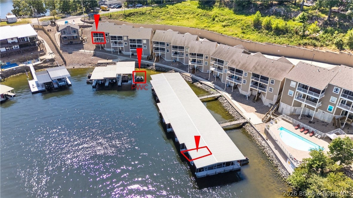 Why settle for an ordinary condo—or pay substantially more for a comparable lakefront home—when this beautifully maintained townhome delivers the space, quality & convenience of both? Located at the 1 MM with spectacular views, this furnished 3-br, 2.5-bath residence offers exceptional value in one of the lake’s most convenient locations. The open kitchen features beautiful cabinetry, granite countertops, a double oven and pantry. Vaulted ceilings continue into the spacious living room & impressive primary suite, which includes access to the upper deck and a private bath with tub & walk-in tile shower. The lower level provides another large family room, wet bar and access to a second expansive deck. Fresh carpet, attractive paint colors, quality furnishings & immaculate condition make this property move-in ready. 2 car attached garage, 12x36 boat slip & 2 pwc slips in the community dock included. Hop on the golf cart and ride from the garage to the pool/dock, or continue to the Bagnell Dam Strip for nearby shopping, dining and entertainment. Exceptional space, outstanding condition, garage, large slip and a premier location, this is lake living without the lakefront-home price tag!