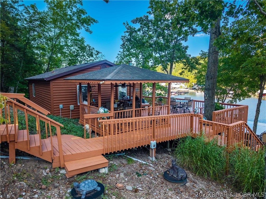 Escape to your own slice of Lake of the Ozarks paradise! Nestled into the hillside of a peaceful no-wake cove, this well-maintained log cabin is the perfect weekend getaway, fishing retreat, or relaxing lake escape. The current owners have made valuable improvements, including a new well and septic system, and the home is being offered nearly turn-key with just a few personal items excluded.

Enjoy easy lake access with a large 3-well dock, perfectly positioned across the cove from a convenient gas dock and convenience store. Fishing enthusiasts will appreciate this cove, which has produced some impressive bass catches right near the dock!

Don’t let the one-bedroom layout fool you—there’s plenty of room for guests! The property also includes a fifth-wheel camper that sleeps at least four, giving family and friends their own private accommodations.

Whether you’re looking for a peaceful retreat, a place to make unforgettable lake memories, or your own fishing hideaway, this charming cabin checks all the boxes. Don’t miss your opportunity to own a little piece of paradise at the Lake!