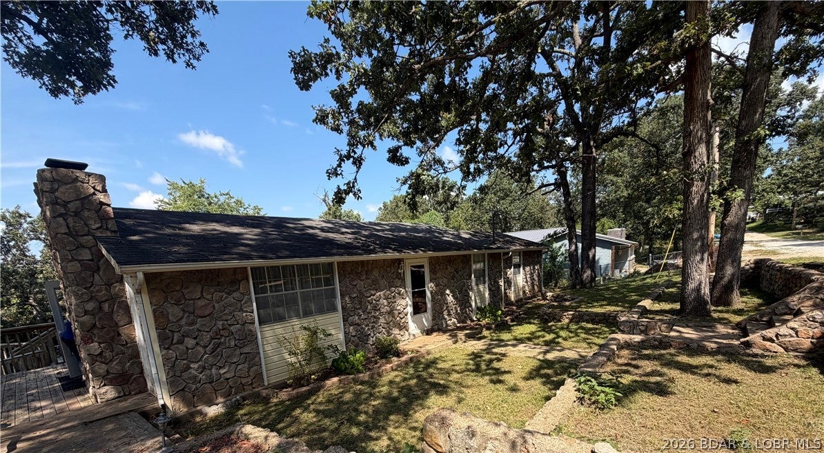 Well-kept 1979 home at the 80MM in Edwards with a beautifully maintained yard and thoughtful updates throughout. The interior features new carpet, fresh paint, Corian countertops, laminate kitchen flooring, and all new 2025 kitchen appliances. Ceilings have a clean knockdown finish for a modern look. A brand-new heat pump is included and stored in the detached 2-car garage, which has electricity and space to build an upstairs apartment. Enjoy the 36-ft deck with an octagon martini bar area, perfect for relaxing or entertaining. The home offers three sets of energy-saving French doors that bring in great natural light. Property includes a small storage building, an easy-access crawl space, and a concrete safe room with electricity and plenty of storage. A solid, updated home with great potential and lake-area charm.