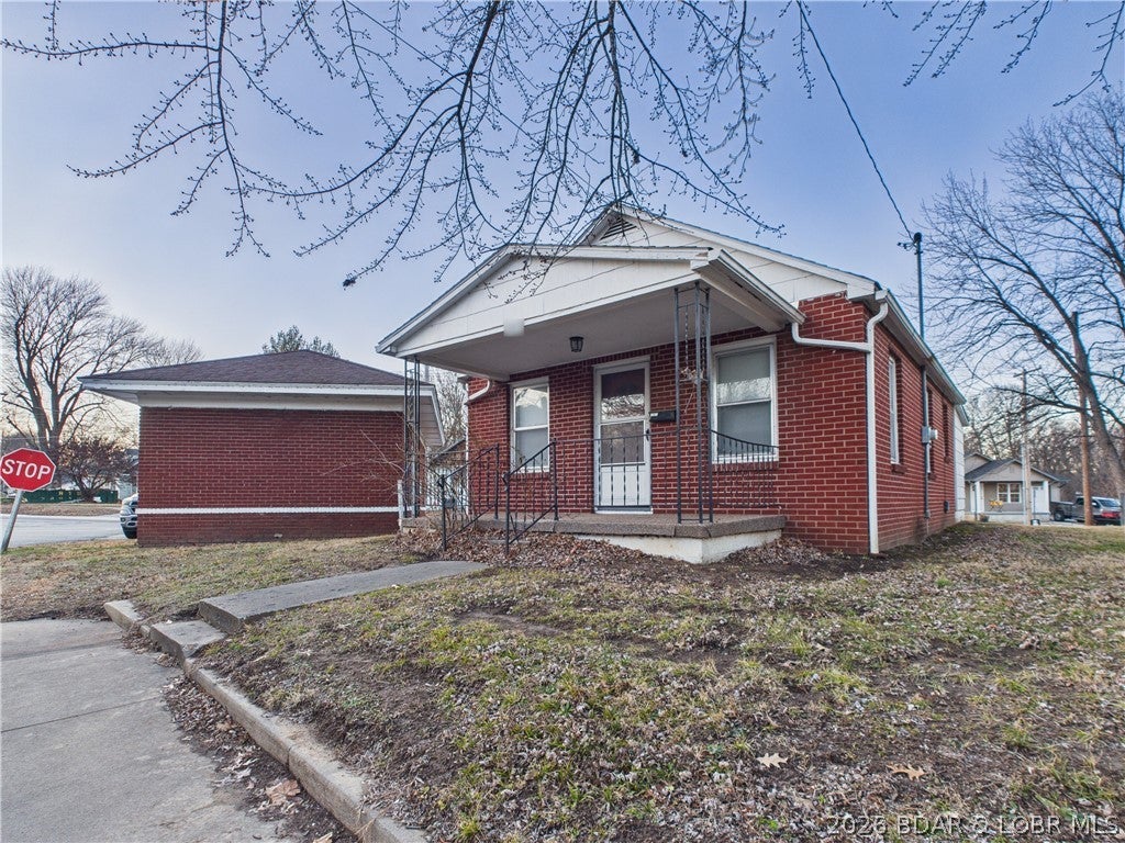 Charming, efficient, and low maintenance home located within walking distance of The Isle Casino, Katy Trail, and Historic Downtown Boonville shops and restaurants. Recent improvements include new furnace and central air conditioning, living room and bedroom carpet, interior paint, LVP kitchen flooring, bathroom vanity. The home is cozy, but has all the amenities you need. The spacious living room will accommodate a large sectional as well as a dining table, it opens up to the covered front porch. The kitchen has ample storage, and the stove and refrigerator are included in the sale. The master bedroom that will accommodate a king bed, is adjacent the kitchen and has the bathroom in it, which is clean and simple. The converted back porch serves as the second bedroom and will accommodate a queen bed; it has plenty of windows for natural light, would also make a great office space. The partial basement has the mechanicals and washer and dryer, which are negotiable. The detached one-car garage used to be a vintage gas station and has lots of character. It could be used as a garage, converted back to the original gas station layout, or remodeled for more living space.  Corner lot.