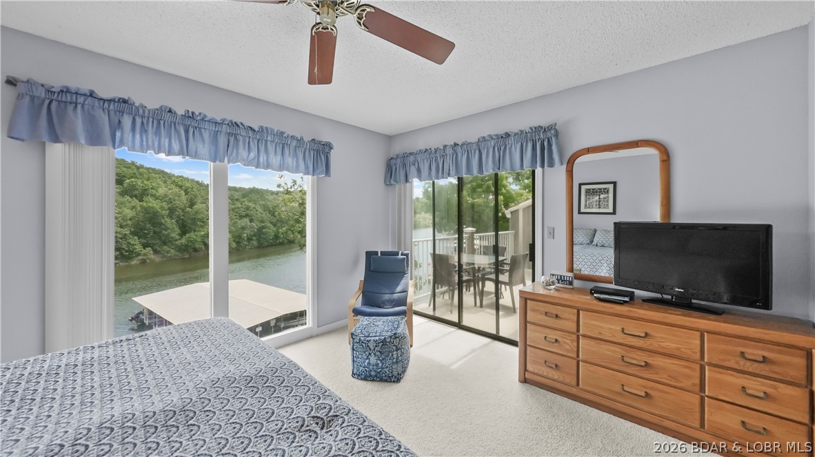 Top floor, vaulted ceiling, panoramic views of Lake of the Ozarks State Park that are permanent because that shoreline will never be developed. Unit B11 at Lazy Days on the 3 mile marker of the Grand Glaize arm in Osage Beach is a fully furnished, updated 2-bedroom 2-bath condo with a 10x24 boat slip included, vacation rental opportunity and a price of $265,000 that is hard to argue with. Updated in 2020 with new vanities, fixtures, and stylish interior doors, this condo is completely turn-key. Lazy Days is one of the most well managed complexes on Lake of the Ozarks and the association budgets reserves properly so nothing catches owners off guard. The complex qualifies for conventional financing, which keeps the buyer pool strong and supports long term value. Owners and guests can swim directly off the no wake cove dock, two pools, two playgrounds, a grilling pavilion, an onsite ice machine, and boat and trailer parking round out a complex that is genuinely easy to own. The Lake of the Ozarks Shootout finish line is visible right from the property, and the nearly $500 million Oasis at Lakeport resort is just down the road.