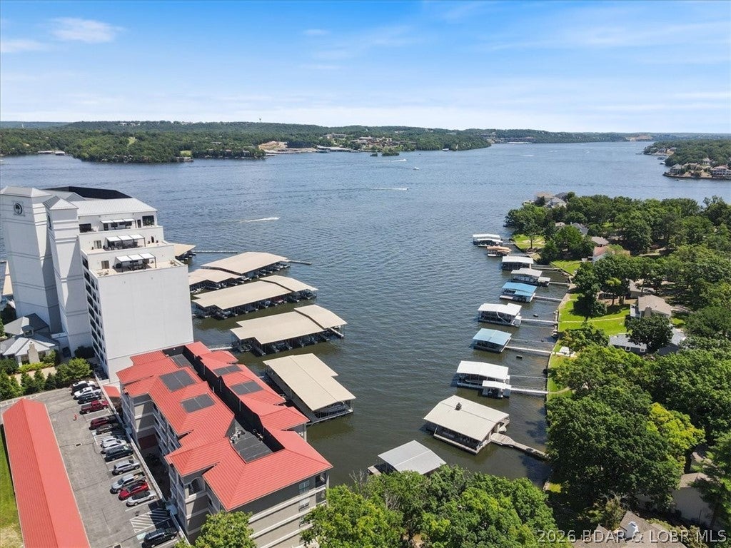Luxury Lakefront Living at Majestic Pointe! Located at the 12MM in an exclusive gated community of only 24 units, this beautifully updated 3BR/3BA condo offers the perfect blend of comfort, style, and convenience. This desirable lower-level unit features elevator access from driveway to dock, providing easy, no-step living. The open-concept layout is designed for entertaining, with granite countertops, tiled backsplash, updated appliances, and a bright, spacious living area. Step outside to the screened-in, tiled deck and enjoy peaceful lake views the ideal setting for morning coffee or sunset relaxation. The spacious primary suite includes a jetted tub, walk-in shower, and updated finishes. Enjoy beautifully maintained grounds, a lakefront pool, and easy access to your 12x32 boat slip. Whether you’re seeking a full-time residence or a weekend retreat, this exceptional condo delivers the ultimate Lake lifestyle.