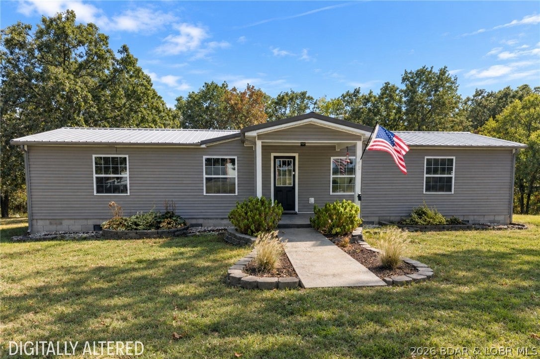 Privacy, charm, & income potential come together on 3.5 peaceful acres just 20 mins from Osage Beach! This inviting 3-bedroom, 2-bath home offers a quiet, country-like setting with beautiful curb appeal and plenty of flat yard space to enjoy. Inside, the open-concept layout creates an effortless flow between the kitchen, dining, and living areas, making the home feel warm, spacious, and ideal for everyday living. The primary suite features a walk-in shower, while the back deck provides the perfect place to relax and take in the peaceful surroundings. A private sauna adds an unexpected touch of luxury. What truly sets this property apart is the separate Airbnb space—a charming 1-bedroom, 1-bath camper complete with its own private hot tub and fire pit. Continue using it for income potential, create a private retreat for guests, or enjoy the extra space yourself. Just 10 mins from Lake of the Ozarks State Park, giving you easy access to hiking, boating, swimming, and everything the outdoors has to offer. Whether you're searching for your first home, a peaceful getaway, or a property with added earning potential, this one offers a unique opportunity close to all the Lake has to offer!
