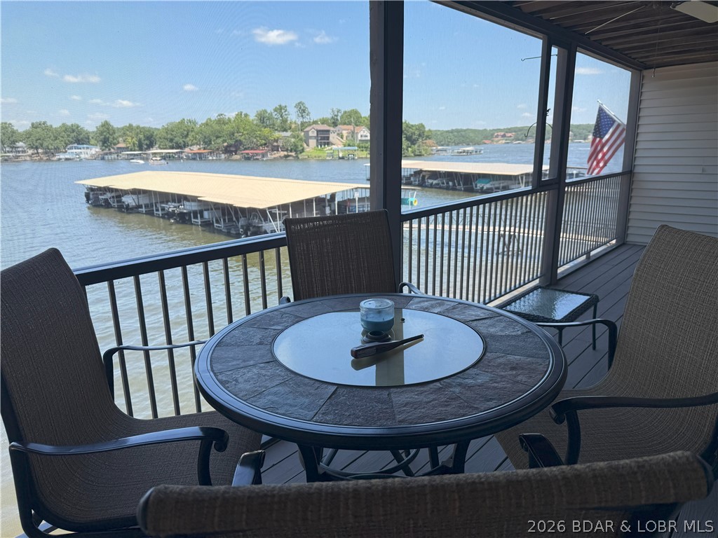 This is a really nice highly desired WALK IN unit with LVP flooring and recently rescreened porch. Boat hoist is an 8000# poly lift available. Shorty Pants and Redhead are really close and all the rest of Osage Beach fun spots are close as well!  Short, convenient drive to land restaurants, shopping, Oasis Amusement Park when complete, and hospital services as well.  Two bedrooms and one bath, great pool and so convenient to all of Osage Beach, golf just around the corner!  Super view down toward the main channel.  Relax enjoy the view before and after you get out on the water!  Well taken care of unit.  Boat is for sale also.  come buy this unit and start having fun!