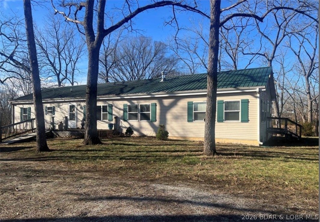 This is a beautiful setting close to town but yet private. This is an open floor plan well kept modular home with a large open kitchen with custom cabinets and center island. Master has a full bath with jetted tub and separate shower as well as a big walk in closet. The 2 remaining bedrooms also have walk in closets and one of those bedrooms has its own full bath. Also has a large screened in back deck that overlooks the very stocked pond. There is also a 1 bdrm guest house with 1 car garage on property as well as a detached garage and other outbuildings. The home sits on 15 beautiful park like acres. Roof was replaced end of 2024. This would make a great place for that homestead you have been looking for. The carpet needs some care and seller will allow an allowance for replacement. Owner is willing to subdivide acreage for right price. Bring all reasonable offers to motivated seller.