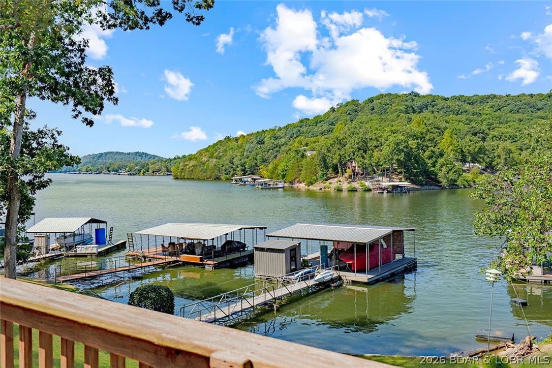 FISHERMAN'S PARADISE 80 FEET OF LAKEFRONT, A 2-WELL DOCK, BOAT RAMP AND DEEP WATER! Here is an opportunity to own your own piece of Lake of the Ozarks without the upkeep of a large lake home. Located in Jackson Hollow Cove at the 3 MM of the Little Niangua, this charming 1-bedroom, 1-bath lakefront cabin sits on a gentle lot with an easy walk to the water. IN A. NO-WAKE COVEThe 2-well dock with two 12x32 slips, a boat hoist, double PWC lift, and swim platform has deep water, 23 feet under the dock! Two decks provide plenty of outdoor living space to take in the lake views. There is a fire pit down by the waters edge. Very close fun lake venues such as The Cave Bar and Grill, Bulldogs Beach House, Pebble Bay Beach Club, and the Naughti Fish Rum Bar. There is room to add-on the home going towards the water, you could add a bedroom and bath and a nice covered porch! Or keep it as it is, and have a place to park your boat without marina fees! Call today this one won't last! (please beware of scammers, this Listing is for SALE, not rent. Photos and information that show it rent at a deep discount are FAKE. Do not send those people any money they are criminals!)