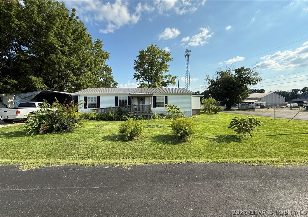 Welcome to small town living in Tipton! This 2004 modular home offers 1,344 square feet with 3 bedrooms and 2 full bathrooms, all situated on a spacious .55-acre corner lot. Mature landscaping adds curb appeal, while the tilled backyard is ready for a garden, outdoor projects or additional recreation space. The property also includes a carport, detached two-car garage/metal building, storage shed and fenced dog pen, providing plenty of room for vehicles, tools, pets and hobbies. Inside, the home has received several cosmetic updates and offers a functional layout with comfortable living spaces. The roof is approximately seven years old, and the home is connected to public water and sewer. Some additional finishing touches could make this property truly your own. A great opportunity for buyers looking for space, useful outbuildings and the charm of living in the welcoming community of Tipton.