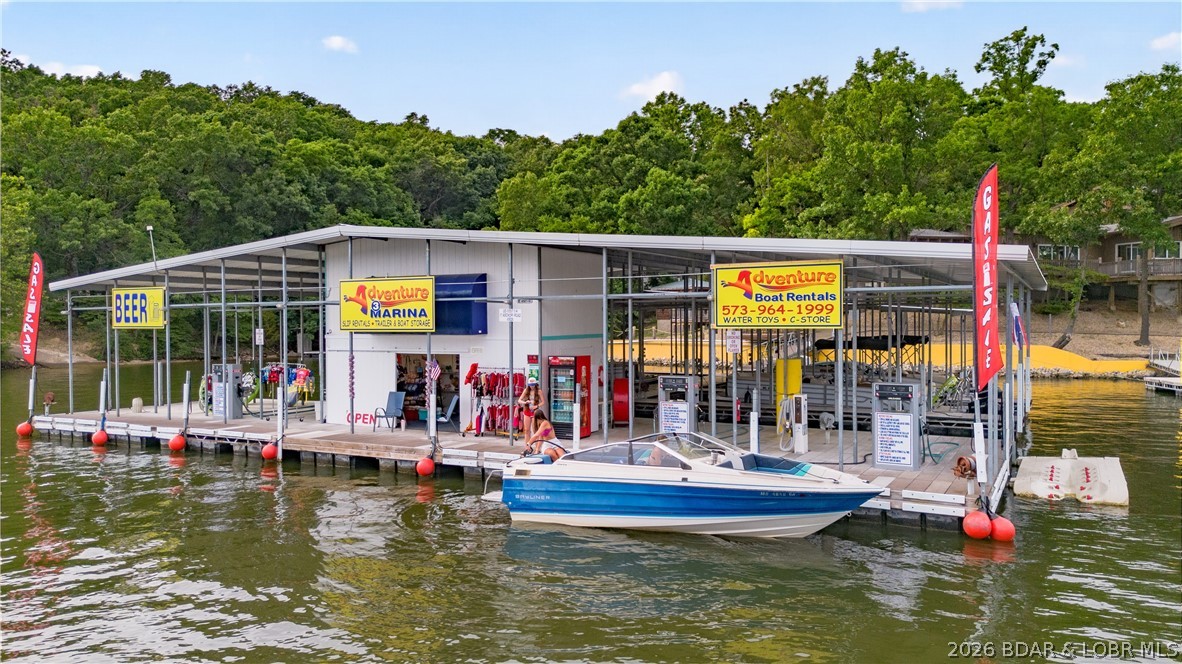 Investment Opportunity at Lake of the Ozarks – 3 Mile Marker, North Shore! Rare chance to own a marina w/tremendous upside potential.This unique waterfront property offers multiple income streams & possibilities for expansion. The property features 20 boat slips, boat ramp, service dock, swim platform, ample parking & a 40x60 shop building ideal for marina operations, storage or additional business opportunities.The fuel dock has been updated with new gas dispensers, new upper level septic & new well pump is ready for a new owner.Included on the property is a charming lakefront home currently operating as an Airbnb, 2 additional rental homes providing steady income, & 4 RV spaces. With room for development and expansion, this property presents a rare opportunity to create a premier waterfront destination. Whether you're looking to expand a marine business, develop additional rental accommodations or build your vision of the ultimate Lake of the Ozarks marina, this property offers the location, infrastructure and potential to make it happen. Marinas with this combination of waterfront acreage, existing income, expansion potential & prime North Shore location rarely become available.