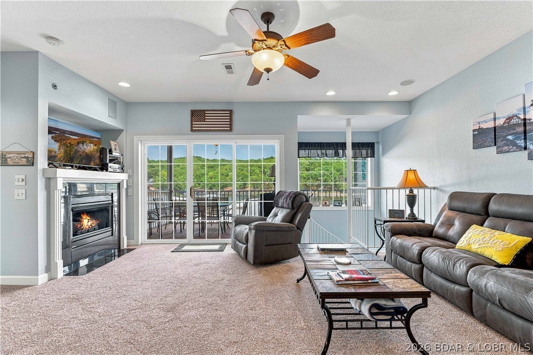 Rare 2-level, 4BR/3BA luxury waterfront condo at the premier 1-Mile Marker of Lake of the Ozarks! Located in an elite gated community with elevator access to your door and the docks, this unique layout is a rare find.The main level features an open-concept layout combining a living room, dining room, and large kitchen with a breakfast bar. Enjoy stunning lake views from your 2 decks: the upper is screened, and the lower is open. The premier primary suite boasts lake views, a walk-in closet, dual vanity, a walk-in shower, and a jetted soaking tub, the perfect place to relax after a day on the water. Two bedrooms and a full bath complete this level.Take the space-saving spiral staircase down to the lower level entertainment hub, featuring a family room with a wet bar, beverage cooler, and a fourth lakeside guest bedroom. Outstanding outdoor spaces include a front patio with a storage closet and piped-in gas for your grill. Step right off your lower deck to your included 12x32 boat slip and 2 PWC spaces with lifts.Complex amenities feature gate code entry, a lakefront pool, a hot tub, and a playground.Turn Dreams to Reality, Call Today!