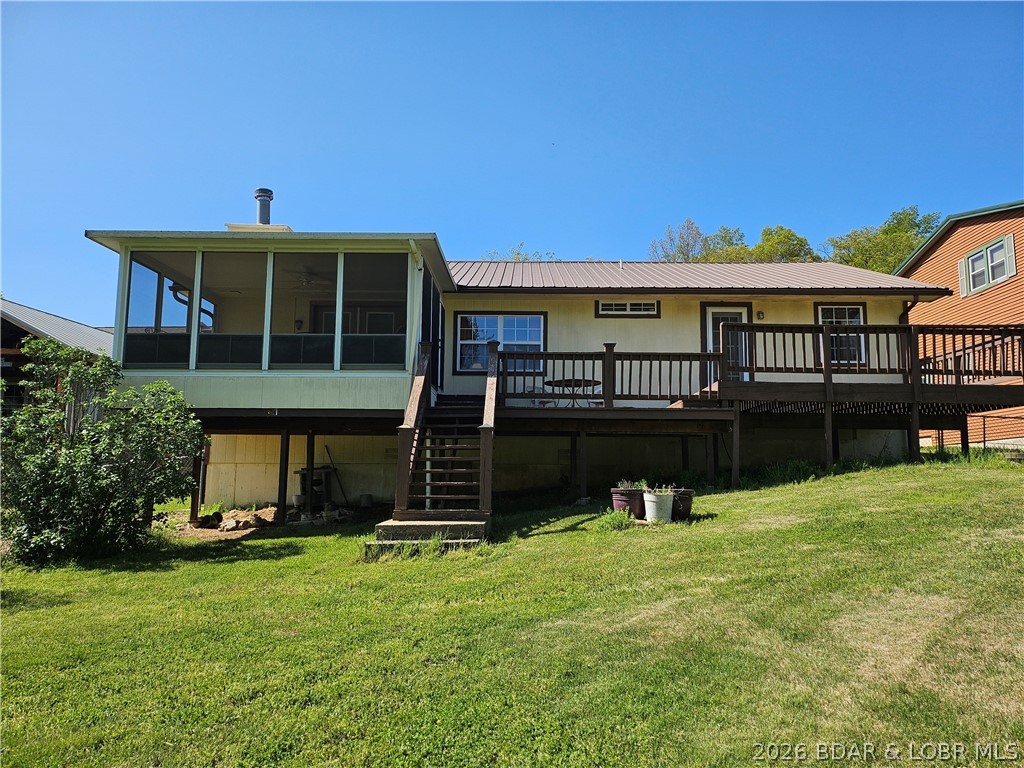 This lakefront homes has many pluses: one level living, attached garage, gentle roadside & lakeside yards, fenced lakeside yard that's great for kids & pets, screened sun room on lakeside with unique window panels that you can either pull up or push down to completely close the room for protection from the weather or have the breeze flow just from the top or bottom, beautiful oak Bella hardwood floors, granite countertops in kitchen with plenty of counter space and cabinets, huge pantry in hall, a beautiful custom window above the kitchen sink for a view outside, a wood burning stove in the living room. Home has 3 bedrooms with a 4th non-conforming bedroom (could also be used as bonus room or an office or play room.  There are 2 and a half bathrooms.  The laundry room has a huge storage closet with a partial closet rod to hang clothes from the dryer.  The laundry room has a half bath plus an additional small sink. The door in the laundry room leads into the attached garage. You don't want to miss checking this one out.  There is a 2-well dock at the property, currently has no electricity to the dock.  Water is shallow in winter but a great place to play in the water in the summer.
