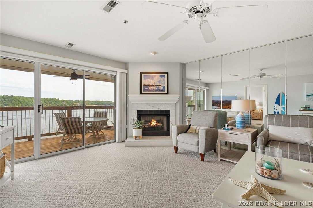 Enjoy your beautiful unobstructed main channel view from the light, open and airy, Walk-In level, very clean, turn-key Ledges condo, that feels like you're at the beach. Located at the popular 21mm, there are many lake front establishments just a short distance by car or boat. Also close to shopping, activities, and hospital. From the moment you walk in, you will love the incredible main channel lake views-with No Docks! The lakeside master suite features a wall of windows to watch the waves coming in, as well as a full bath with double sinks and a spacious walk-in closet with storage. The guest bedroom with full and queen size beds and the adjacent full bathroom with new toilet. The closets include lots of storage. The laundry closet is conveniently located near the kitchen with a full size washer & dryer. Also included are a newer refrigerator and dishwasher. This unit includes a 12x30 boat slip. The complex includes 2 pools,one on the point and a second one that features a playground and sandy beach area in the cove. Watch the boats and the waves coming in from the new deck that is newly stained,with an electric grill that's included ! Not a rental and the great condition shows!