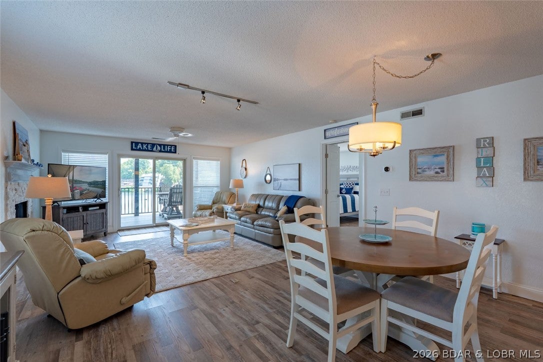Talk about location- this unit is one of the best locations in the best building in the complex! Newly renovated and shows like a dream- this walk-in unit is one of the larger floor plans and has a newer installed deck that offers a stunning lake views! Upon entry you will be impressed with the updates, including newer LVP flooring with tasteful colors and the furnishings are included! The Open Great room offers an electric fireplace w/stone surround, newer patio doors and windows (minus- the primary suite windows). Lakeside Primary Suite with walk-in closet with private vanity and walk-in tiled shower. Updated kitchen with stunning cabinetry and granite countertops, newer stainless steel appliances. 2nd En-suite offers an oversized room with additional windows. Updated full bathroom that also services the condo guests. Third bedroom offers a walk-in closet. Oversized laundry room with newer HVAC with transferable warranty on parts. Being Sold "turn-key" with a few exceptions. Complex offers a great lakeside pool with swim area and a clubhouse. Overflow parking available with trailer parking and tennis courts. Excellent location by land & water with direct stoplight access off HH.