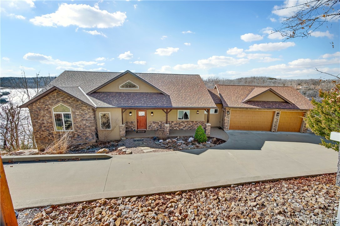Offered by its original owners, this lovingly maintained 5-bed, 6-bath lakefront home on Linn Creek Cove was built to bring people together. Soaring ceilings, rich wood accents, and open light-filled spaces flow naturally to the outdoors, where deep year-round water and a concrete dock set the stage for memories. The dock features two 12x30 slips, a 12x22 swim platform, and a 4x8 storage locker ,everything needed for a summer of boating, swimming, and lakeside gatherings. A three-car garage handles all the gear, and the large unfinished space below is ready for a guest suite, game room, theater, or fitness space. Cross Creek offers pool and clubhouse access, STR potential, and a 1031 exchange opportunity. Pre-listing inspected with a one-year home warranty included. Built with intention. Ready for your family's next chapter.