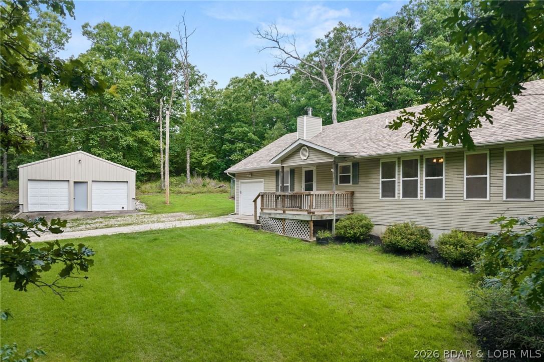 Escape to your own private haven with this 3-bedroom, 3-bathroom home tucked away on 20 beautiful acres in Eldon. Perfectly balancing space, privacy, and functionality, this property is ideal for hobbyists, creators, and those who love the outdoors. The inviting living space features wood-look flooring and a cozy wood-burning stove, creating a warm atmosphere for relaxing or entertaining. The functional kitchen offers a raised breakfast bar, plenty of cabinetry, and a charming textured backsplash. Just off the kitchen is a cozy formal dining room and a bright sunroom with tiled flooring and scenic views invite natural light inside. The spacious master bedroom features a generous walk-in closet for ample storage. The walk-out basement includes a large unfinished area, offering an excellent second workshop space or room to grow. Outside, storage options abound with an attached one-car garage and a substantial detached two-car garage that easily doubles as a workshop. Surrounded by lush Missouri timber, this estate offers a rare opportunity to enjoy peaceful country living with endless room to explore.