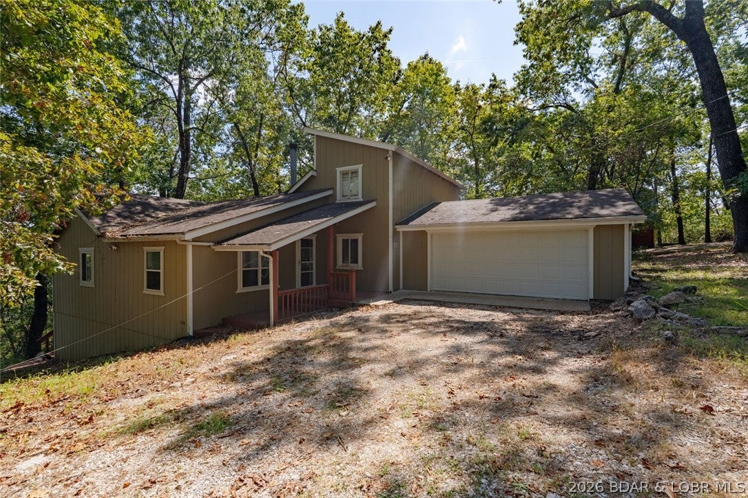 Lake Access, Privacy & Convenience at Lake of the Ozarks! Enjoy the best of lake living with this 3-bedroom, 2-bathroom home offering a 2-car garage and access to the beautiful Lake of the Ozarks. Located just far enough from town to provide a sense of privacy and peaceful surroundings, yet only approximately 15 minutes from everyday conveniences, dining, shopping, and entertainment. Residents can enjoy access to the lakefront clubhouse, making it easy to relax, connect, and take advantage of the lake lifestyle. Whether you're looking for a full-time residence, weekend getaway, or investment opportunity, this property offers a wonderful combination of comfort, location, and access to everything Lake of the Ozarks has to offer.