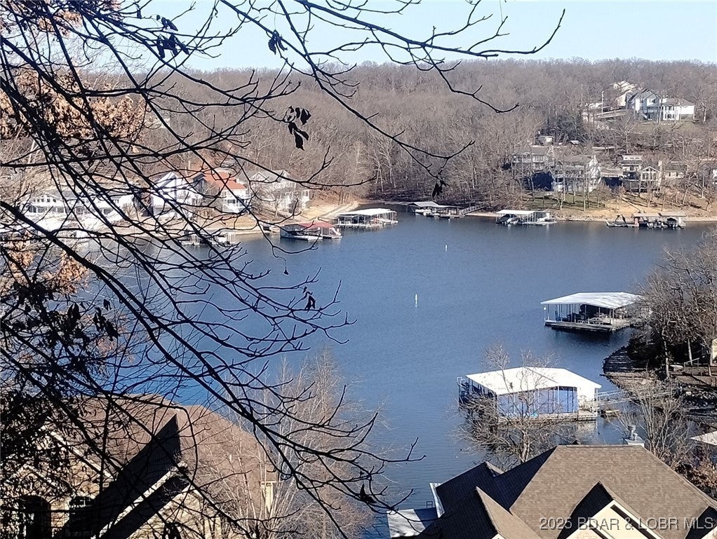Check out this hard-to-find available lake view building site in Beacon Pointe. The site contains 19,063 square feet/.43 acres according to Miller County. There is also a 12' x 32' boat slip in the Beacon Pointe community dock available for sale. Great neighborhood with a community pool, a clubhouse, a playground and a super convenient location. The clubhouse has a covered patio with a fireplace, a game room/meeting room, a kitchenette and two half baths. Close to the Bagnell Dam Strip, Osage National Golf Course, a movie theater, shopping, restaurants, nightlife, convenience store and to Highway 54. There are building restrictions in Beacon Pointe that have helped keep the community as a sought after location. City streets, City water and City sewer are all a plus! Association fee is $750 per year. Boat slip fees are $1,600 per year. Boat slip assessment is for maintenance and repairs to dock and partially for paying for the wave break.