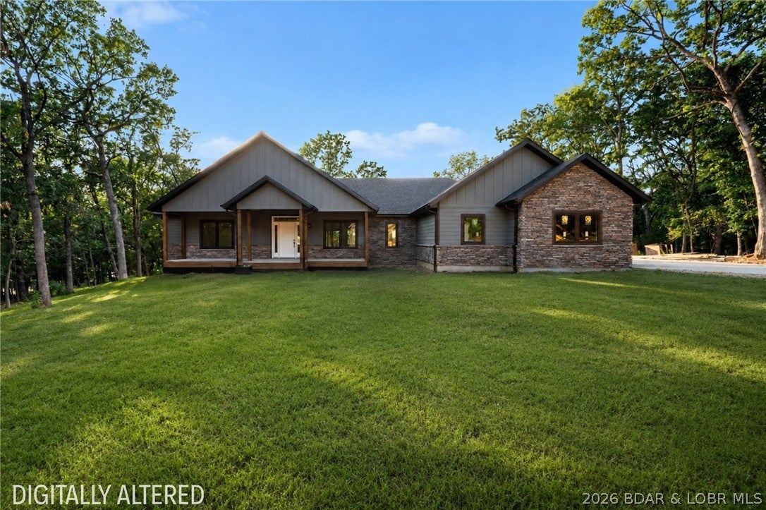 Thoughtful design, quality finishes, and everyday functionality come together beautifully in this spacious home. Enjoy convenient entry-level access directly from the oversized 3-car garage, which is both heated and cooled for year-round comfort. Inside, floor trusses provide a solid foundation while all-natural gas appliances add efficiency throughout. The kitchen is designed to impress with custom cabinetry, quartz countertops, and a separate butler's kitchen featuring a low-profile microwave and second refrigerator hookup—perfect for entertaining and keeping the main kitchen clutter-free. A beautiful stone fireplace anchors the living area, creating a warm and inviting focal point. Both secondary bedrooms feature their own private full bathrooms, offering added comfort for family and guests. Outside, enjoy a large 16x12 covered back deck, expansive covered front porch complete with a porch swing, and a generously sized lot. From October through April, beautiful seasonal lake views add another special touch to this impressive property.