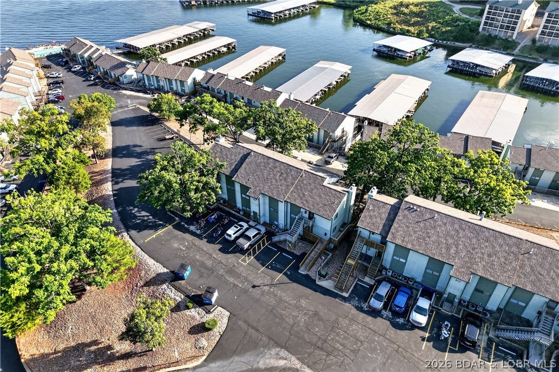 Welcome to one of the nicest Subdivisions at the lake!  The minute you walk in to this unit you will be "WOW" completely update condo offers lake vies and a turn key lifestyle.  Features include a bright white kitchen with granite countertops, stainless steel appliances, new beautiful vinyl plank flooring throughout, this condo blends modern style with cozy comfort.  Motivated sellers, & all the extremely nice furnishings are included, also New HVAC system and the convenience of your in-unit washer & dryer.  Short term rentals are allowed, making this property an ideal investment or the perfect year around personal retreat.  The gated community offers incredible resort-style amenities, including lakefront pool, and indoor heated pool, a hot tub, swim dock, playground, tennis courts, business center, clubhouse, concrete boat ramp, boat trailer parking, and a fish cleaning station.  Located at the 12MM, with access to the lakes finest restaurants, shopping, and entertainment by land or by water!  If your searching for a relaxing, low maintenance getaway or an income producing rental, this property has it all!