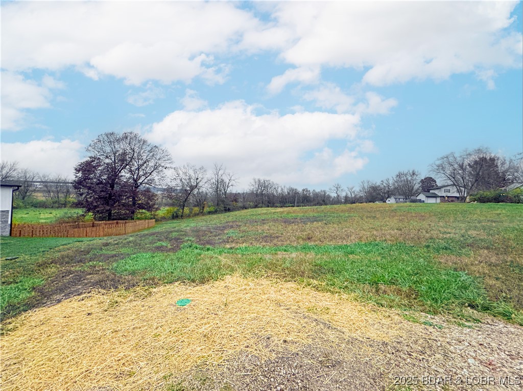 Discover this beautiful, build-ready lot just outside of Eldon — a town known for its friendly atmosphere, strong sense of community, and proximity to the Lake of the Ozarks. This gentle open parcel lies just off W Bourbon Street. City water, sewer, and electric hookups are available at the edge of the property — ready for your builder to connect. As surrounding homes fill in and the area develops, the cul-de-sac will be blacktopped. This is a rare opportunity to build within city limits without breaking the bank.
Eldon is known as the “Gateway to Lake of the Ozarks,” and the lake is under 15 minutes away — ideal for boating, fishing, swimming, and lakeside fun.  Eldon offers a quality school district, a solid local economy rooted in manufacturing, agriculture, retail, and services, and a welcoming, community-oriented lifestyle. Multiple lots are available.