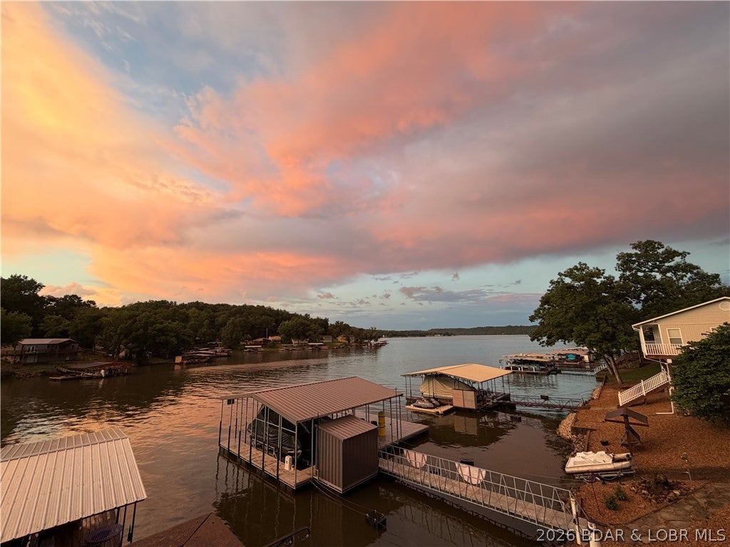 Looking for a Lake of the Ozarks property where you can arrive, unpack and start enjoying the lake? This completely turnkey Pine Cove home is ready for you! Enjoy beautiful lake views, a comfortable layout, covered decks and plenty of space for family and guests. The home has been well maintained and features a newer HVAC system, ample storage and great outdoor living space. The private 2-well covered dock offers approx. 10' of water at full pool and includes boat lifts. AND YES—THE BOATS ARE INCLUDED! The home is being sold completely turnkey, plus a 2007 Bennington tri-toon with 225 HP Evinrude E-TEC and a 1996 Tracker fishing boat and motor. Located across from Patriot Point and close to great waterfront restaurants, this is lake living at its easiest! A recent professional appraisal completed July 2026 valued the real estate at $500,000. List price reflects the appraised real estate value plus the extensive turnkey package and included personal property. Bring your clothes and groceries and start making lake memories!