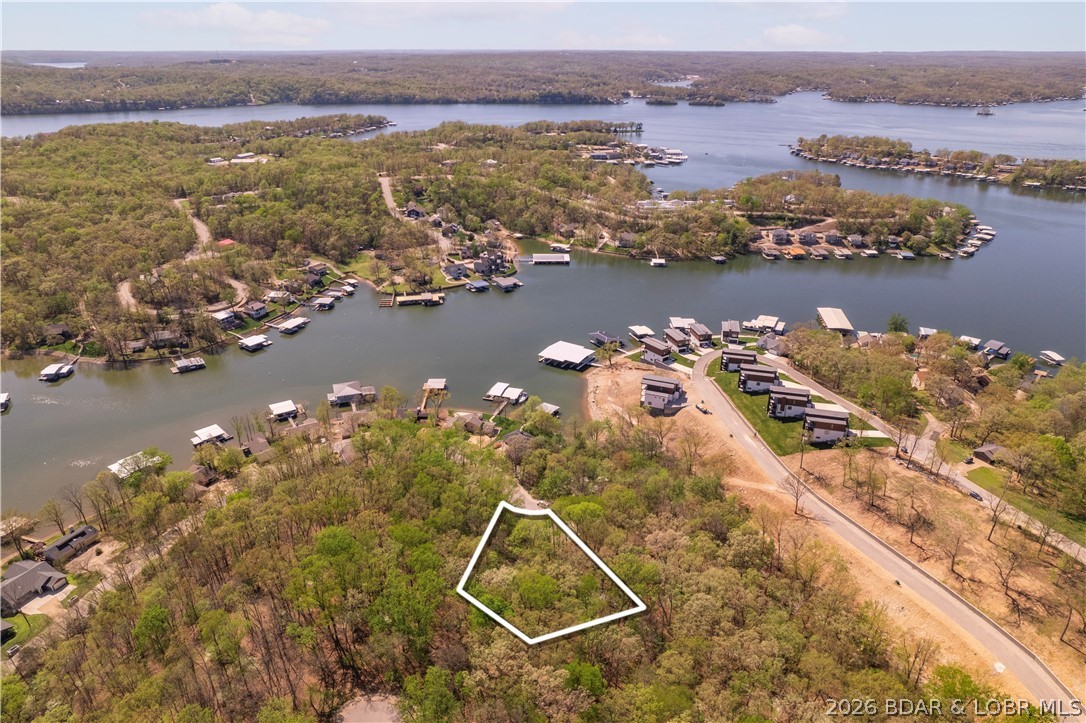 Build your dream home on this spacious cul-de-sac lot in the highly desirable Four Seasons community! Tucked away at the end of the street, this homesite offers a private setting while providing access to an outstanding lineup of amenities. Enjoy indoor and outdoor pools, a fitness center, campground, clubhouse, dog park, pickleball and bocce ball courts, multiple parks and playgrounds, and convenient boat ramps with access to the Lake. Whether you're planning a full-time residence or a vacation getaway, this is an exceptional opportunity to own a premium lot in one of the Lake area's most sought-after communities.