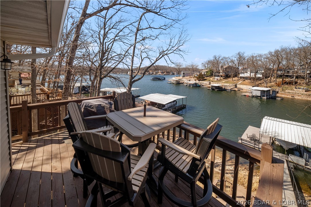 Fun location! Adorable lake house! Lots of outdoor space! This one is made for long lake weekends & drinks at sunset- the kind of property you've been waiting for with a great price point. Perfectly positioned at the 7 Mile Marker directly across from Shady Gators & Camden on the Lake, updated home is in a protected cove with 4 beds, 2 full bath. This location puts you right in the middle of the action while still giving your own cozy lake escape. Inside it is bright, cheerful & tastefully decorated with lakeside windows letting the views pour in. Another big win-pavement all the way to the door so no winding gravel roads & extra parking across street Outside is where this place shines with a wraparound deck, firepit, martini deck & walkout basement leading to your private dock. So easy to jump between boating, swimming & relaxing. When you’re ready to head out,  just minutes from Tap & Grill & the new Buck Creek Marina. And if you’re thinking investment, this home already has rental history, giving you opportunity to enjoy it yourself while it helps pay for the fun. This home has that effortless “kick off your shoes & stay awhile” lake vibe everyone is looking for! Call today