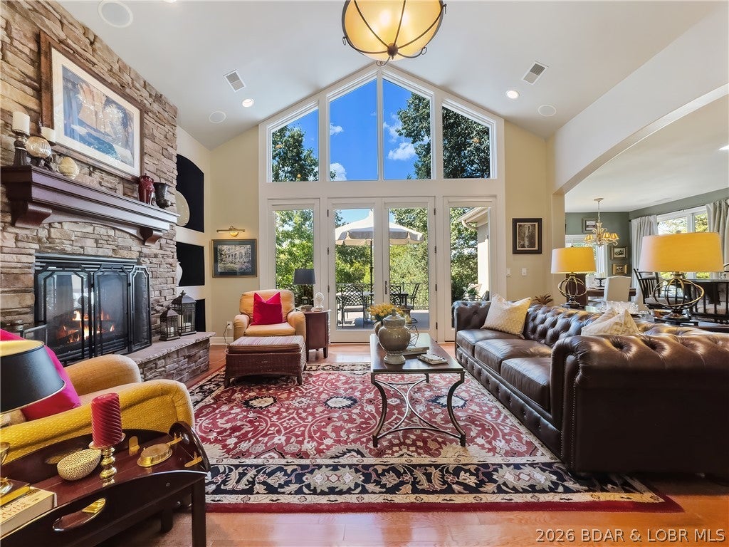 Private, park-like living in the most convenient locations of Old Kinderhook! Corner lot just inside the community, custom-built former builder model offers nearly 4,000sqft of designer’s touch throughout. Enter with soaring ceilings, a stone fireplace, wall of windows, and French doors leading to the wraparound composite deck. The kitchen features custom Mission cabinetry, granite countertops, gas cooktop, walk-in pantry, and generous laundry room. Main level includes a spacious en suite guest bedroom plus private primary quarters with dual vanities, walk-in closet, and deck access. Downstairs offers a second living area, fireplace, wet bar, flexible game/fitness space, two oversized bedrooms with walk-in closets and Jack-and-Jill bath, plus excellent storage. Walk out to a secluded sitting area with stone fireplace sure to be a favorite. Roof/gutter guard in 2023, new HVAC 2025, composite decking, exterior stonework, irrigation, and integrated sound inside and out. 2-car garage. Gas-powered Yamaha golf cart included! Enjoy championship Tom Weiskopf-designed golf course, pools, dining, fitness, racquet sports, lake access, and year-round resort amenities— within a gated community.