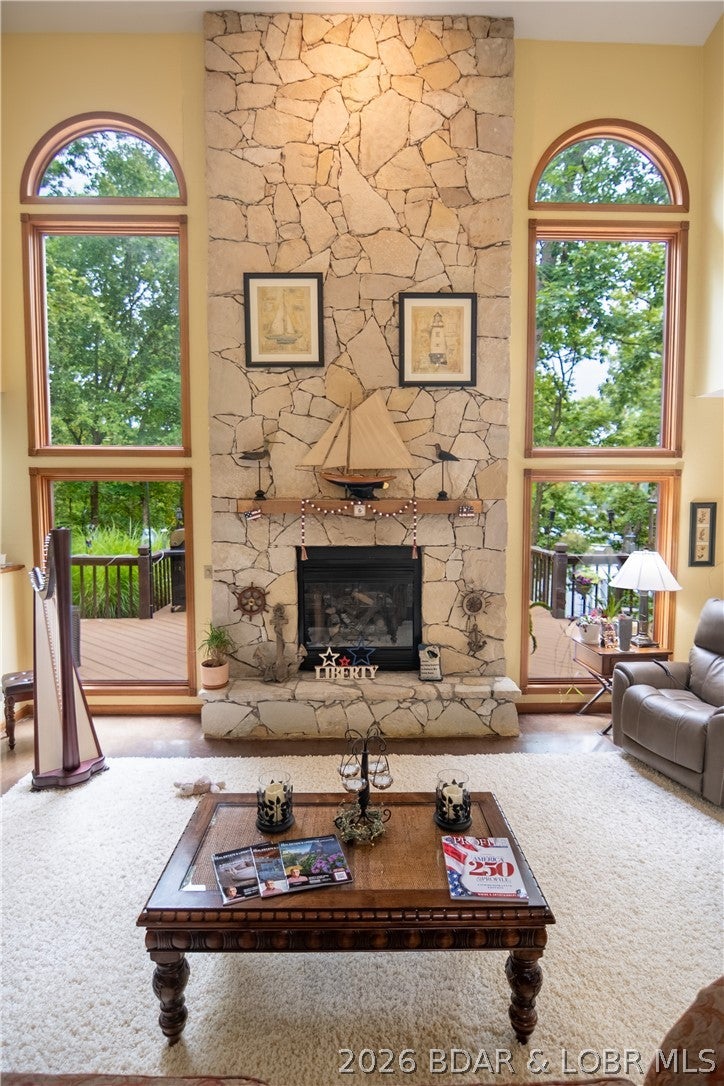 Imagine waking up and walking straight down to the water for a morning swim or launching your paddle boat right from your own backyard! Tucked away on a prime lakefront "A" lot, this unique property offers full, unrestricted shoreline access and breathtaking views without the extra cost of waterfront living. Inside, high vaulted ceilings and a stunning stone fireplace create an awe-inspiring main level, which also features an attached bonus flex room that is perfect for a home office, media den, or kids' playroom. Upstairs, ultimate comfort awaits with 3 spacious bedrooms, each with its own private, attached full bath, plus a handy guest half-bath on the main floor. Outside, the wide, nearly flat driveway leads to a massive three-car garage featuring soaring ceilings and endless upper storage space for all your lake gear. Nestled on a peaceful cul-de-sac street, this dream home is a truly wonderful place to raise a family. This is a very unique design that was only replicated a few times here at the lake. Take visit, fall in love and prepare to enjoy! Agent owned.