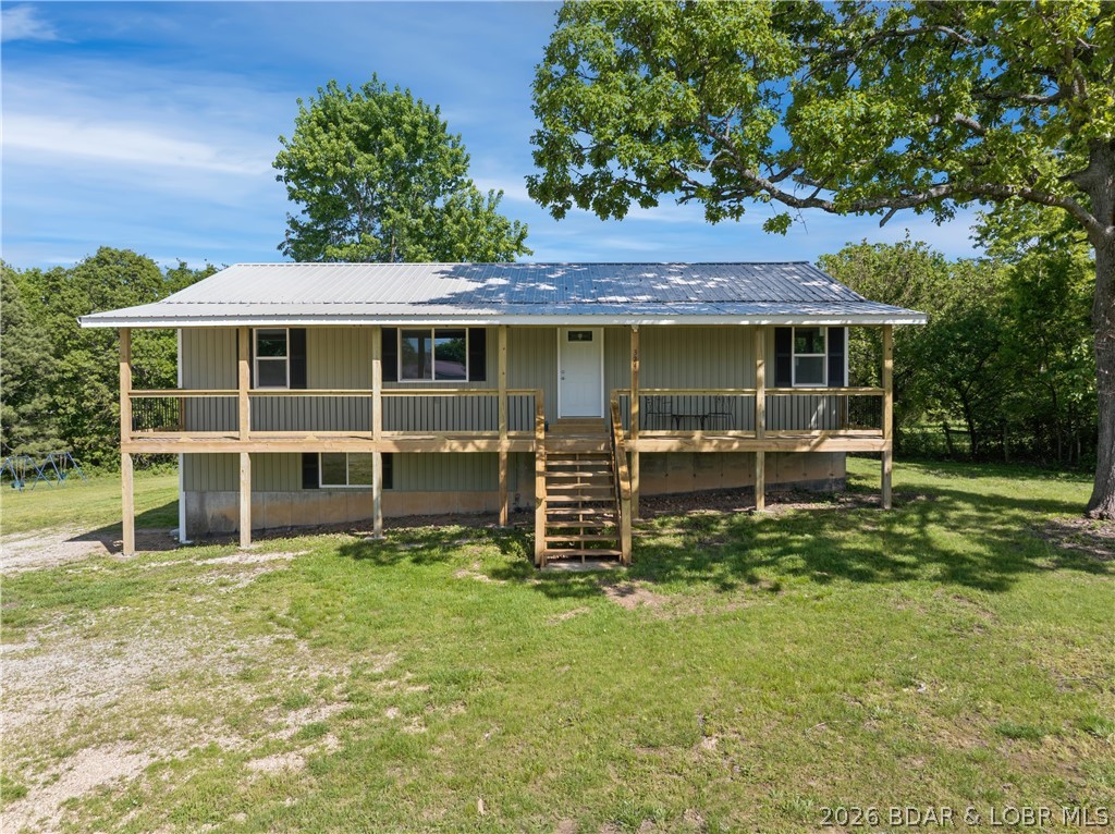 Completely rebuilt from the ground up, 5-bed, 3-bath home in Camdenton delivers space, flexibility, and a true “nothing left to do” remodel. Everything has been redone—roof, siding, windows, HVAC (and ductwork), flooring, appliances, and more. The setup is what makes this one stand out. 2 full kitchens, 2 laundry areas, and a walkout lower level create a natural split for multi generational living, guests, or even separate living quarters if needed. Upstairs ofers a 3-bed, 2-bath layout, while the lower level adds 2 more bed-rooms with a Jack-and-Jill bath-giving you true primary suite options on both levels. No stairs required for lower-level access, which is a big plus for long-term usability.The home sits on a flat, usable .5+acre lot inside Camdenton city limits. Plenty of room to add a shop, garage, or just enjoy the space. Covered front porch adds to the curb appeal and gives you a functional outdoor area right out front.Location checks the boxes too—just minutes to grocery stores, restaurants, schools, and all the Lake of the Ozarks attractions.If you’ve been looking for a large, fully updated home —and don’t want a project—this is one that delivers real value for the money.