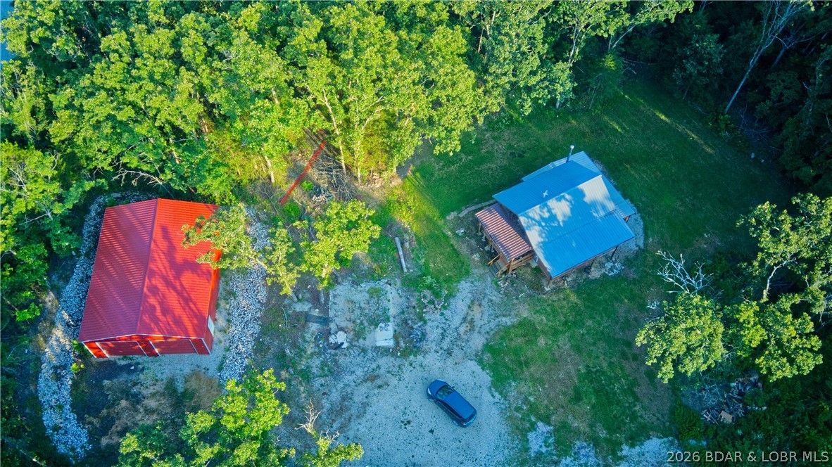 An investment opportunity any outdoors' man could appreciate! Check out this gorgeous log cabin, sat on the front end of a 10.3 acre wooded paradise. This property is proven to be full of wildlife, including deer, turkey, and more! This property has 2 wet weather creeks running through it, and one small hobby pond. Completely fenced in, fully furnished, and truly a turn key opportunity. Inside you will find a cozy open concept kitchen and living room accompanied by a small bedroom that leads out to a porch overlooking your land, and have wildlife ready to welcome you of a morning. Downstairs is where you will find the master bedroom, bathroom, and walk in closet; along with access outside and to your outdoor storage facilities. This property doesn't lack space! With a large lean-to storage shed, and RV sized Garage - this property offers room to spread out! 
Located only 20 minutes from Fort Leonard Wood, this is the perfect investment opportunity. Whether you're looking for a home, an investment, or a hunting cabin for this fall - this cozy property is worth checking out.